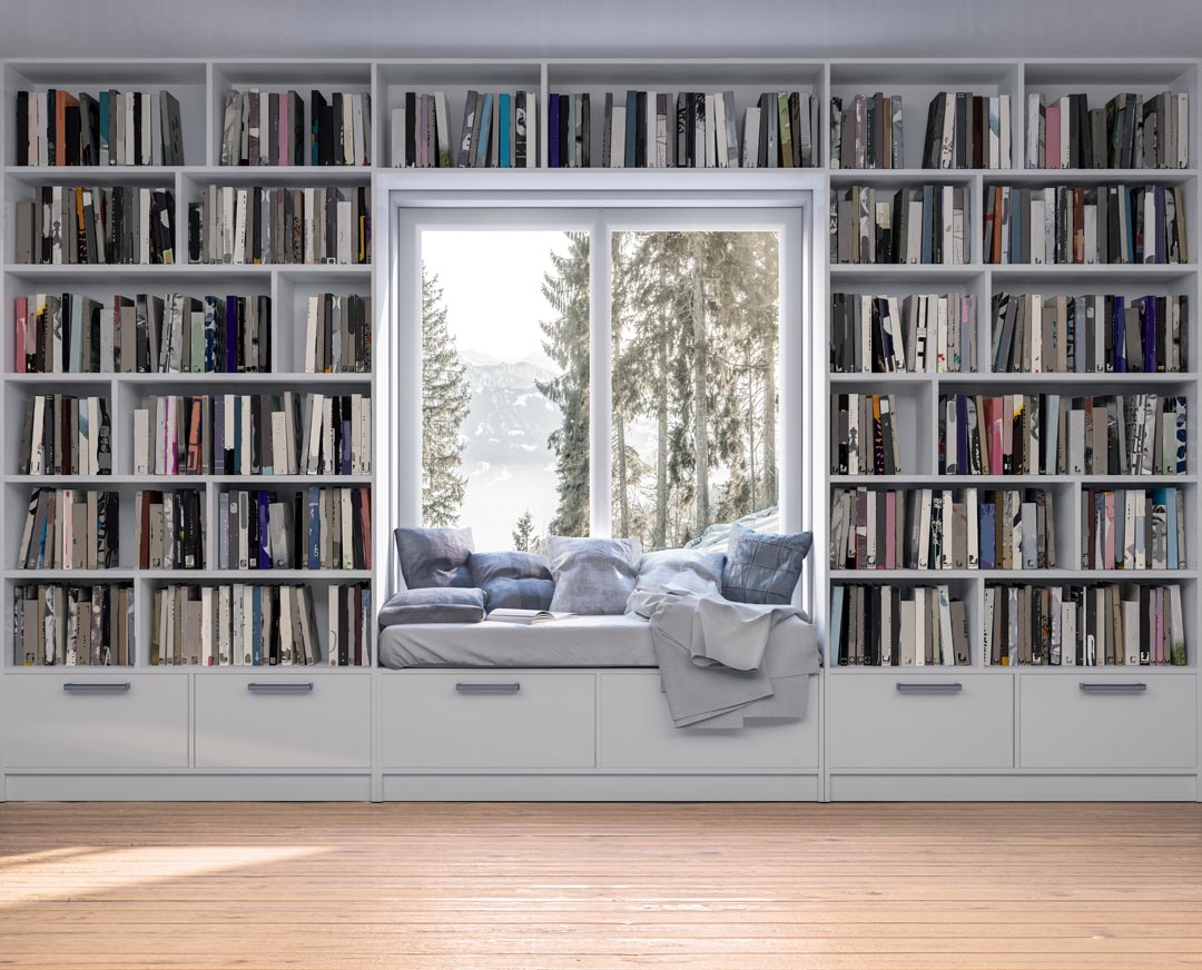 Weiße Bücherwand nach Maß, die ein Fenster umschließt - mit Sitzgelegenheit zum Lesen